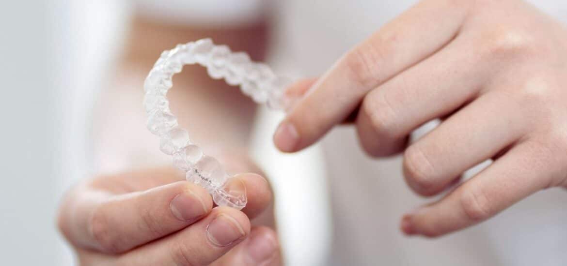 person holding invisalign in hand