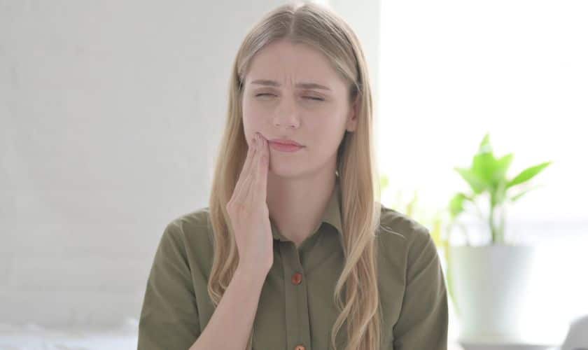 A lady suffering from gum disease pain