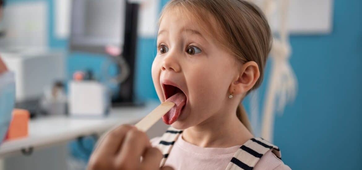 A child having their mouth examined by a dental professional