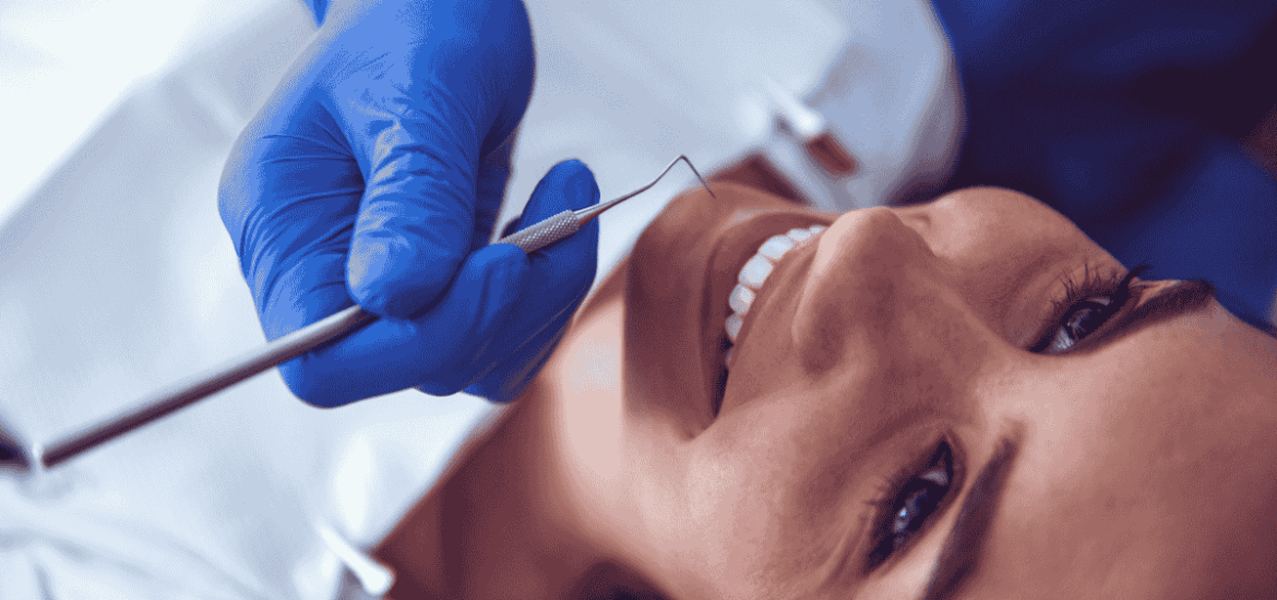 dentist checking women patients teeth during routine checkup