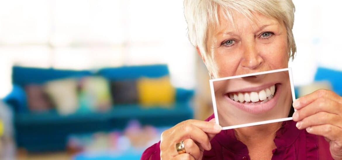 old women holding a image a complete smile