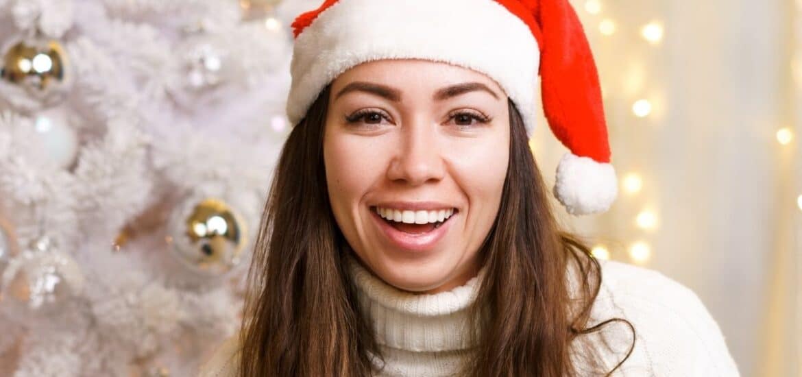 Women showing festive special whiter smile after teeth brightening treatment