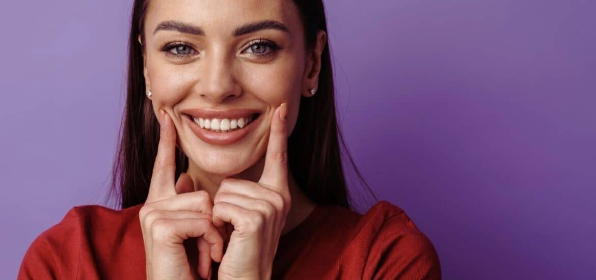 women showing her new smile after cosmetic dentistry