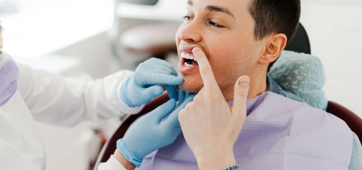 person showing uneven smile for cosmetic dentisrty solutions