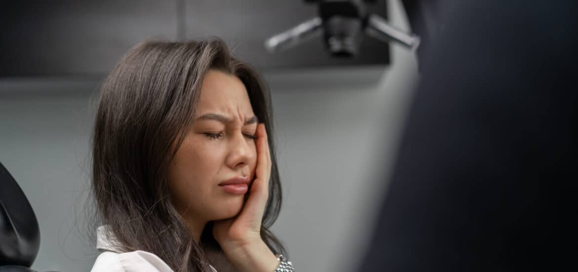 Patient experiencing severe tooth pain while visiting an Emergency Dentist Salt Lake City for urgent dental care and same-day treatment.